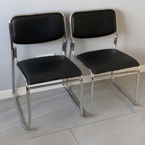 Armless chrome visitor chair with padded seat, ergonomic back support, and sturdy metal frame for office guest seating