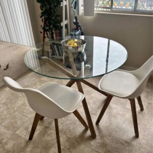 Modern 2-seater dining table with transparent tempered glass top and sleek metal frame, ideal for small spaces elevation and kitchen corners