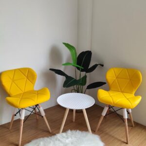 Eames leather visitor seat with padded leather upholstery and chrome metal frame available in white, yellow, and black.