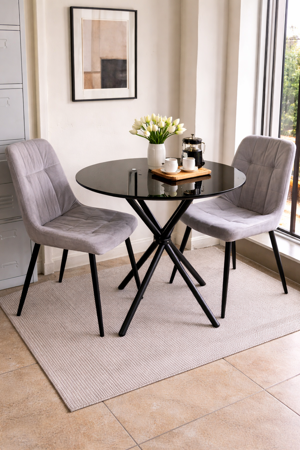 Modern 2-seater dining table with cushioned chairs in a stylish compact dining setup.