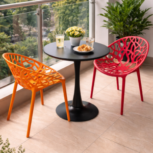 2-seater outdoor dining set with round black table and colorful modern chairs in a balcony setup.