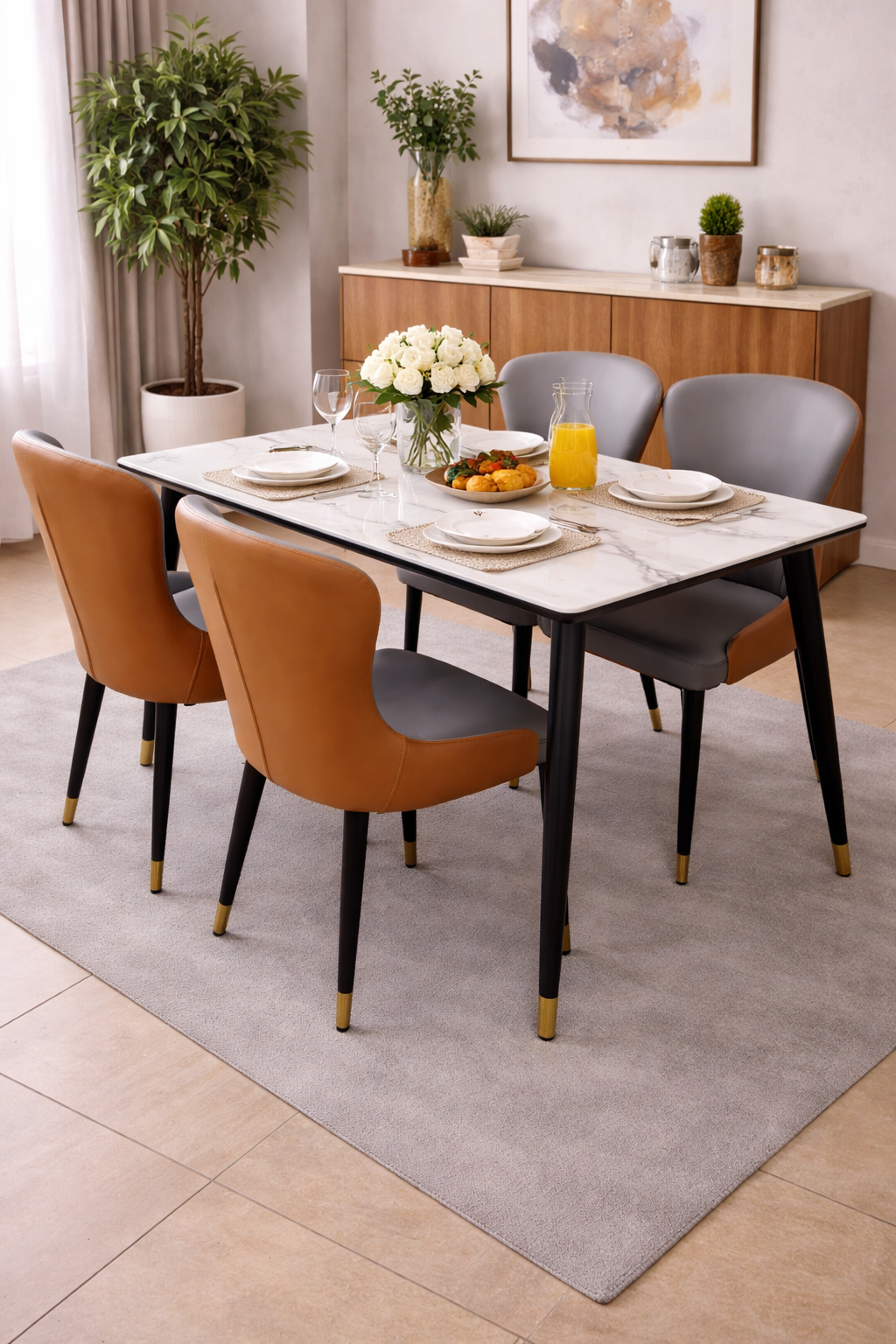 Elegant marble-top dining table with four modern cushioned chairs in a stylish dining setup