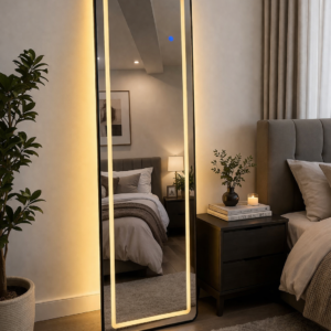 Full-length LED mirror with soft ambient lighting in a modern bedroom setup.