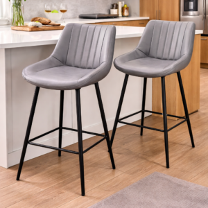 Modern grey kitchen bar stools with cushioned seats and black metal legs placed at a kitchen counter.