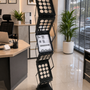 Modern black metal office display stand with multiple tiers for brochures in a professional office setup.
