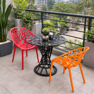 Modern plastic balcony set with round black table and colorful open-design chairs in a stylish outdoor setting