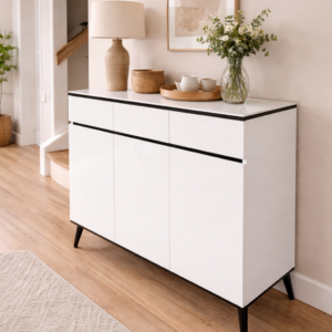 Modern white sideboard console table with black accents placed in a stylish hallway with décor items on top.