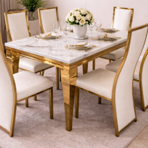 Elegant marble dining table with gold accents and upholstered chairs in a luxurious dining setup.